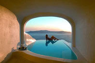 Photograph of a woman beside a pool looking over the horizon